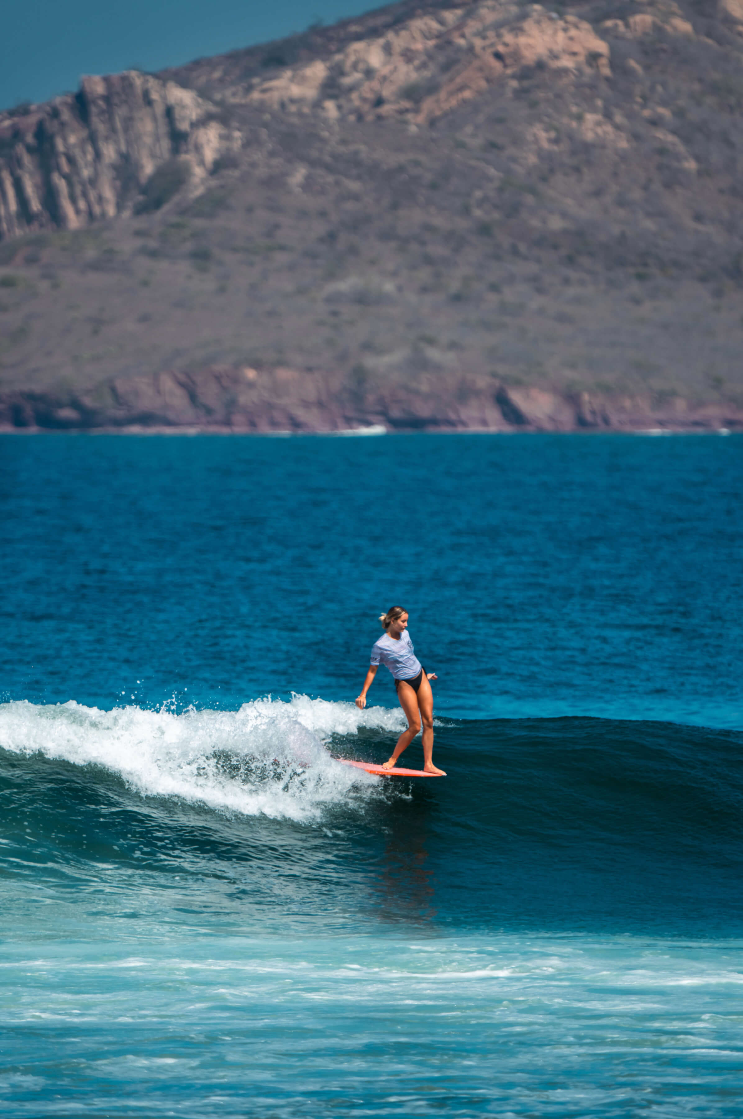 woman riding a wave and leaning back 